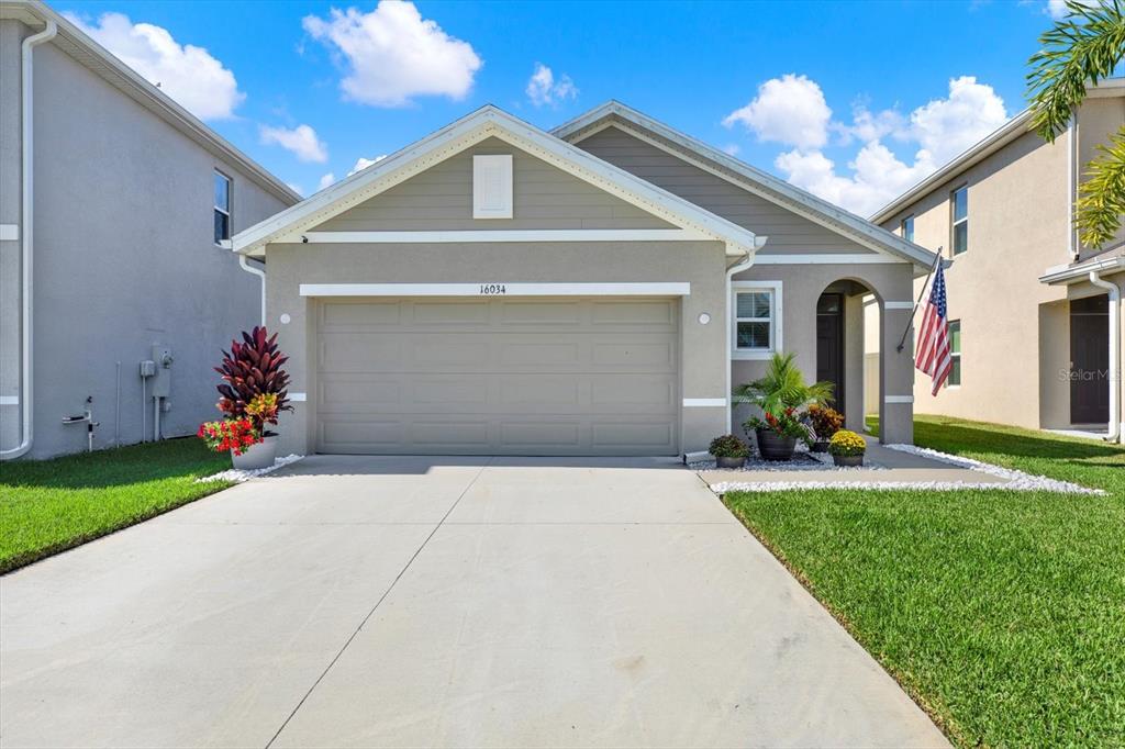 16034 Tuscany Hillside Road Odessa, FL 33556 - Photo 1 of 48 a front view of a house with garden