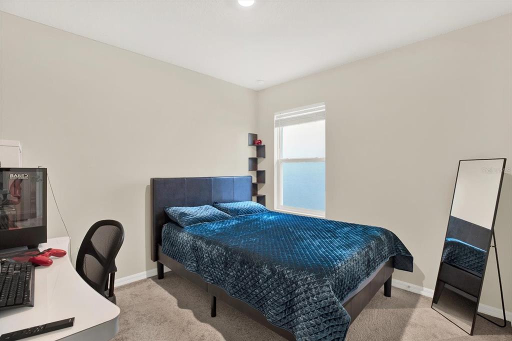 16034 Tuscany Hillside Road Odessa, FL 33556 - Photo 20 of 48 a bedroom with a bed chair and a mirror