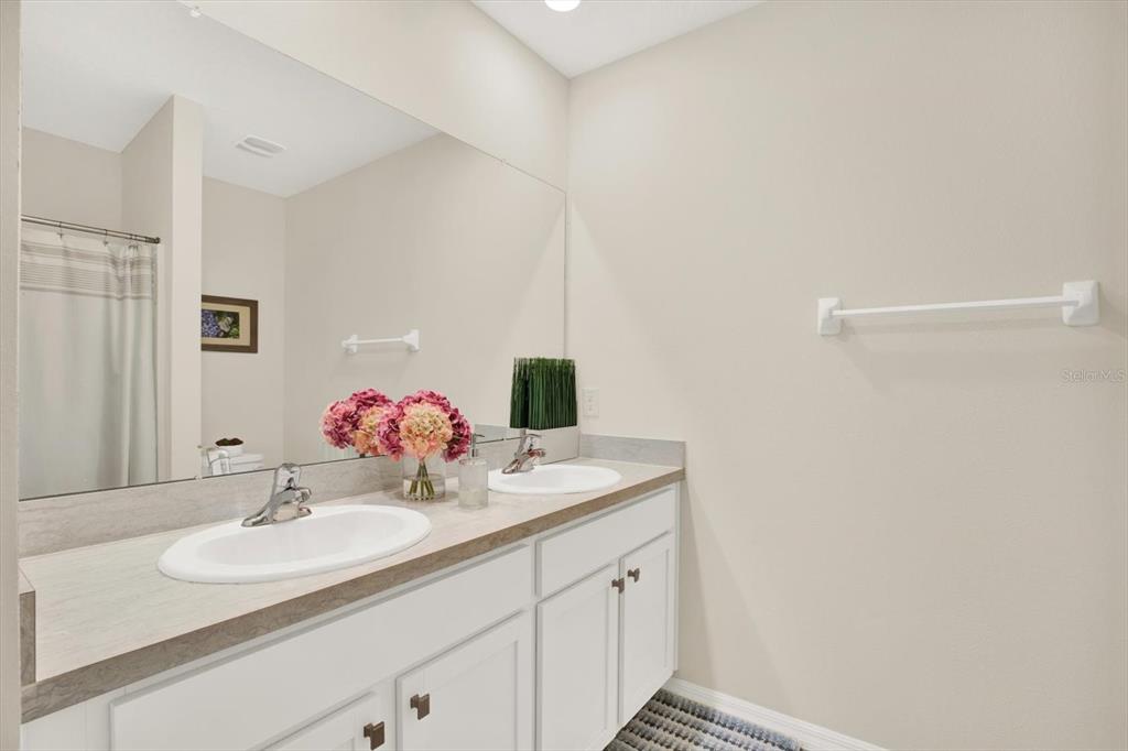 16034 Tuscany Hillside Road Odessa, FL 33556 - Photo 22 of 48 a bathroom with a sink and a mirror