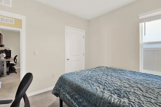 a bedroom with a bed and a chair