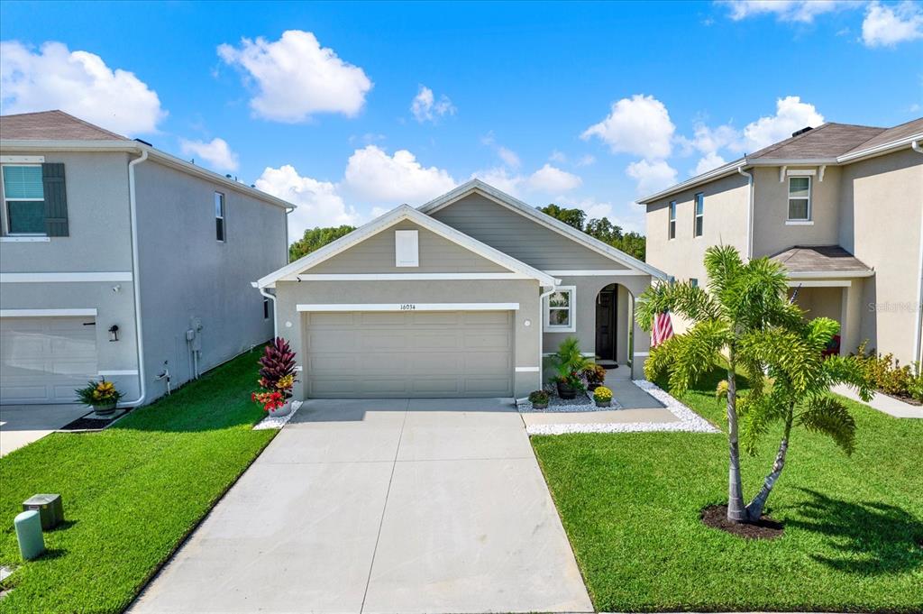 16034 Tuscany Hillside Road Odessa, FL 33556 - Photo 29 of 48 a front view of a house with a yard and garage