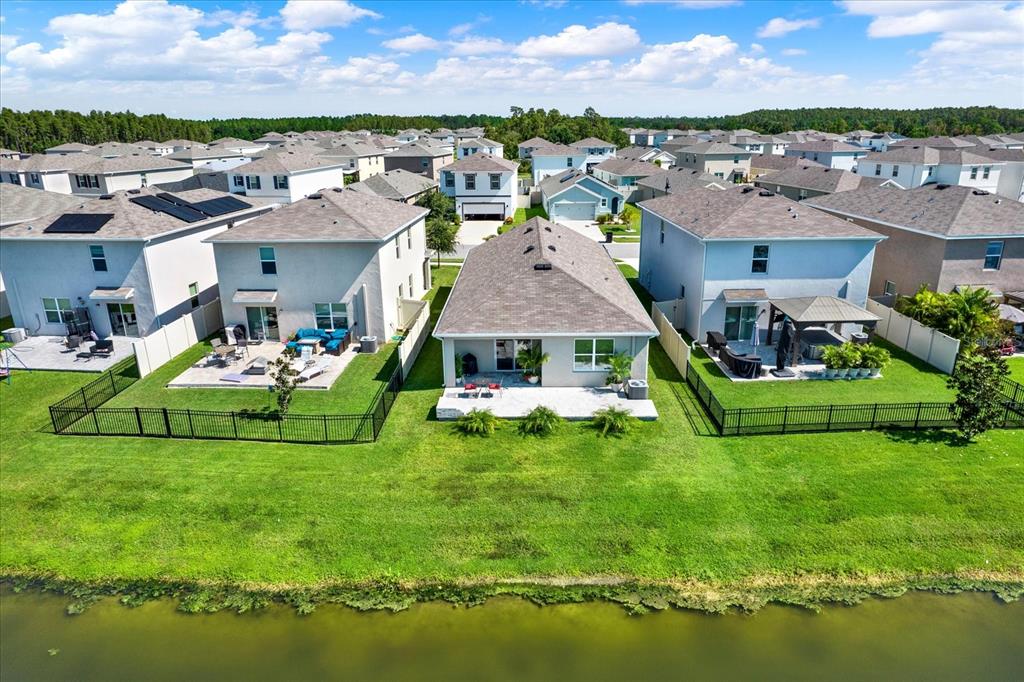 16034 Tuscany Hillside Road Odessa, FL 33556 - Photo 31 of 48 a aerial view of a house with a garden and lake view