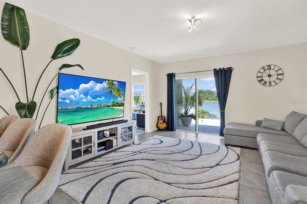16034 Tuscany Hillside Road Odessa, FL 33556 - Photo 6 of 48 a living room with furniture and a flat screen tv