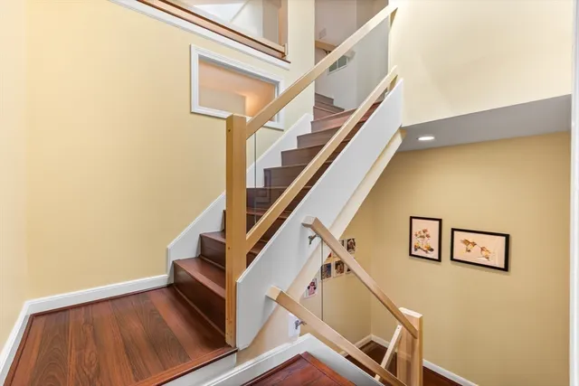 a view of a house with a small yard and potted plants