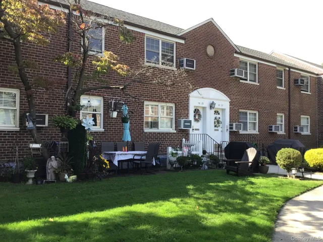 a front view of a house with a garden