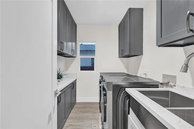 a kitchen with a sink and a refrigerator