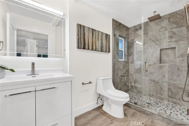 a bathroom with a toilet a sink and a mirror