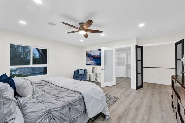 a bedroom with a large bed and a window