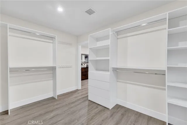 a view of walk in closet with empty racks