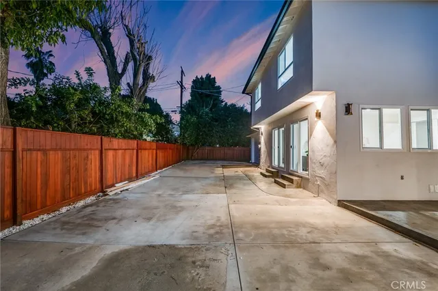 a view of a backyard with garage and plants