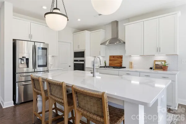 a kitchen with stainless steel appliances a sink counter space and refrigerator