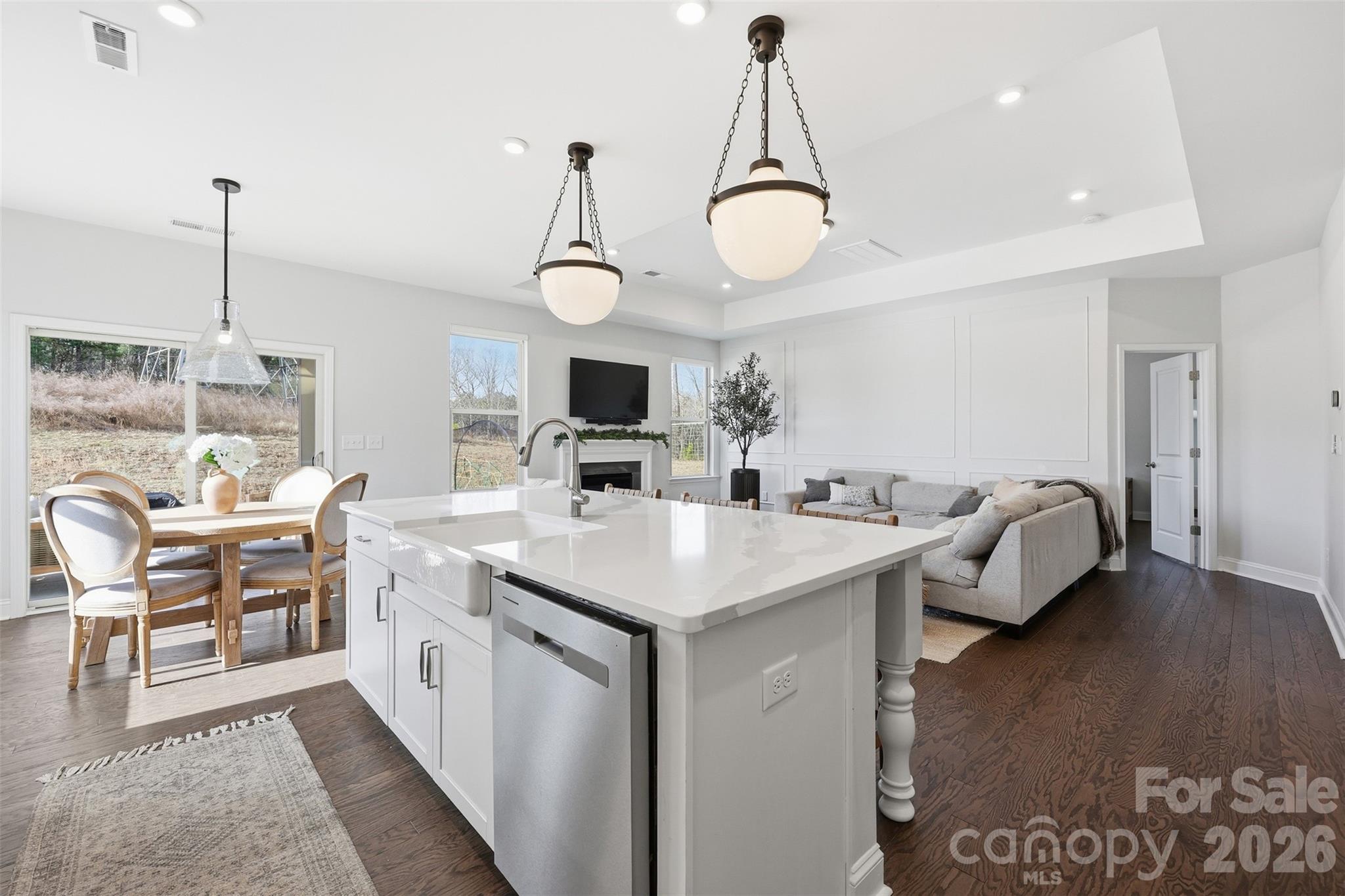 419 Clemson Tree Lane Clover, SC 29710 - Photo 15 of 48 a kitchen with a sink a stove and chairs with wooden floor