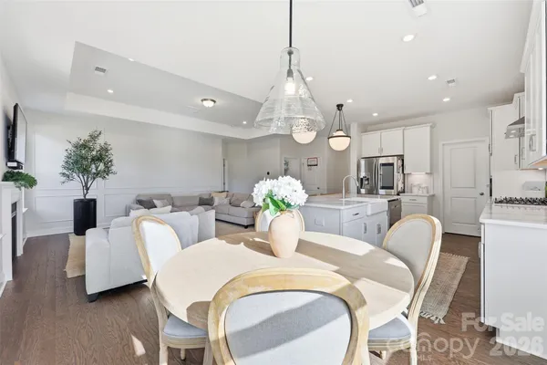 a view of a dining room with furniture and chandelier