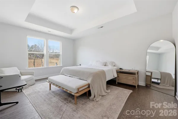 a spacious bedroom with a bed and a couch