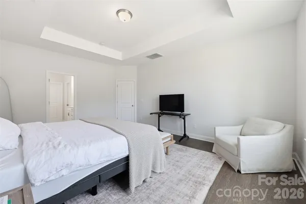 a bedroom with a bed and a couch