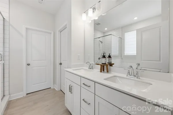a bathroom with double sink and a mirror