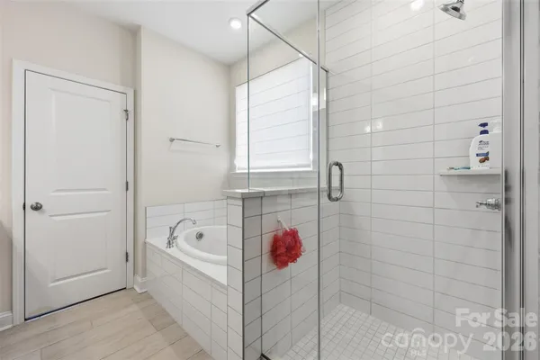a bathroom with a bathtub and shower