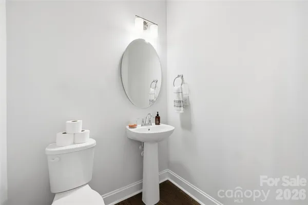 a bathroom with a sink mirror and toilet