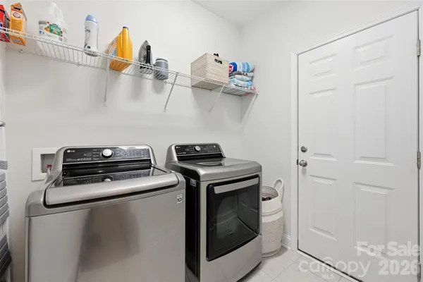 a kitchen with a stove and a wooden floor