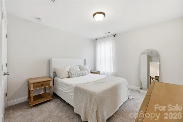 a bedroom with a bed and a night stand