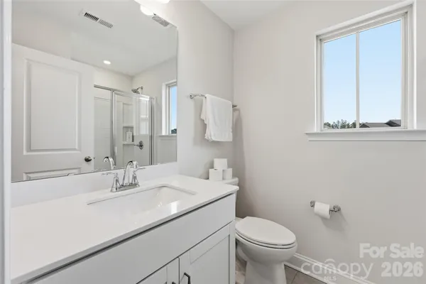 a bathroom with a sink toilet and mirror