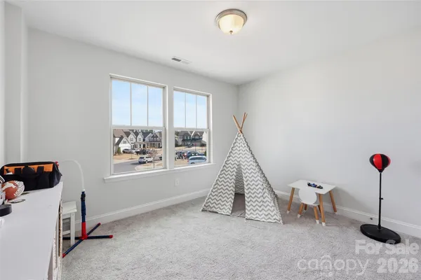 a view of a room with window and white walls