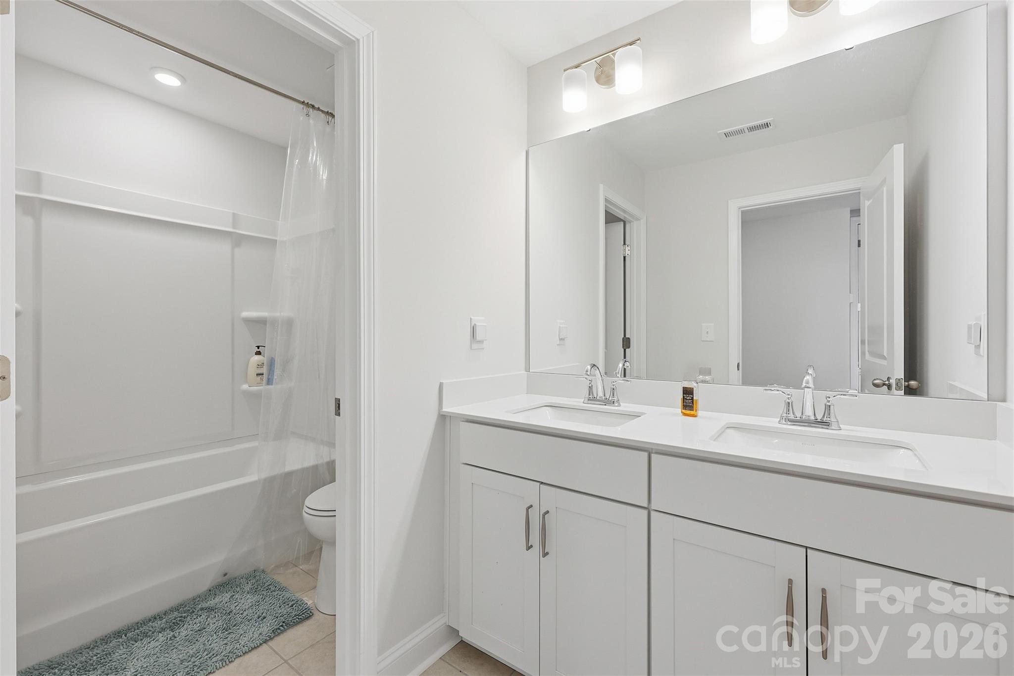 419 Clemson Tree Lane Clover, SC 29710 - Photo 34 of 48 a bathroom with a double vanity sink toilet mirror and bathtub