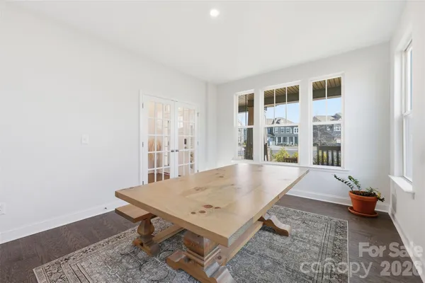 a room with pool table and windows
