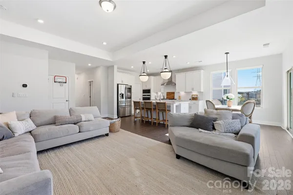 a living room with furniture and kitchen view