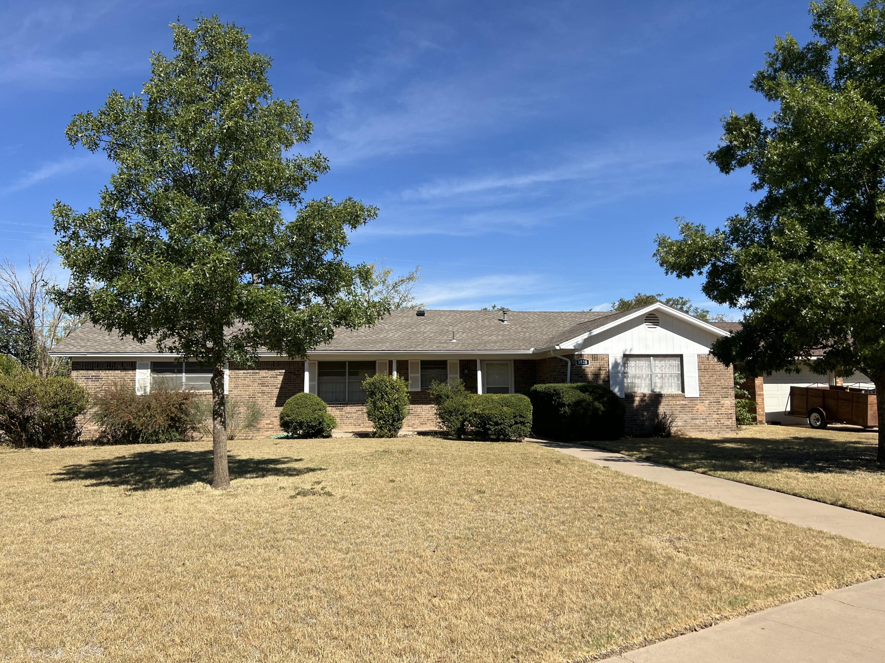 5520 36th Street Lubbock, TX 79407 - Photo 1 of 27 a front view of a house with a yard