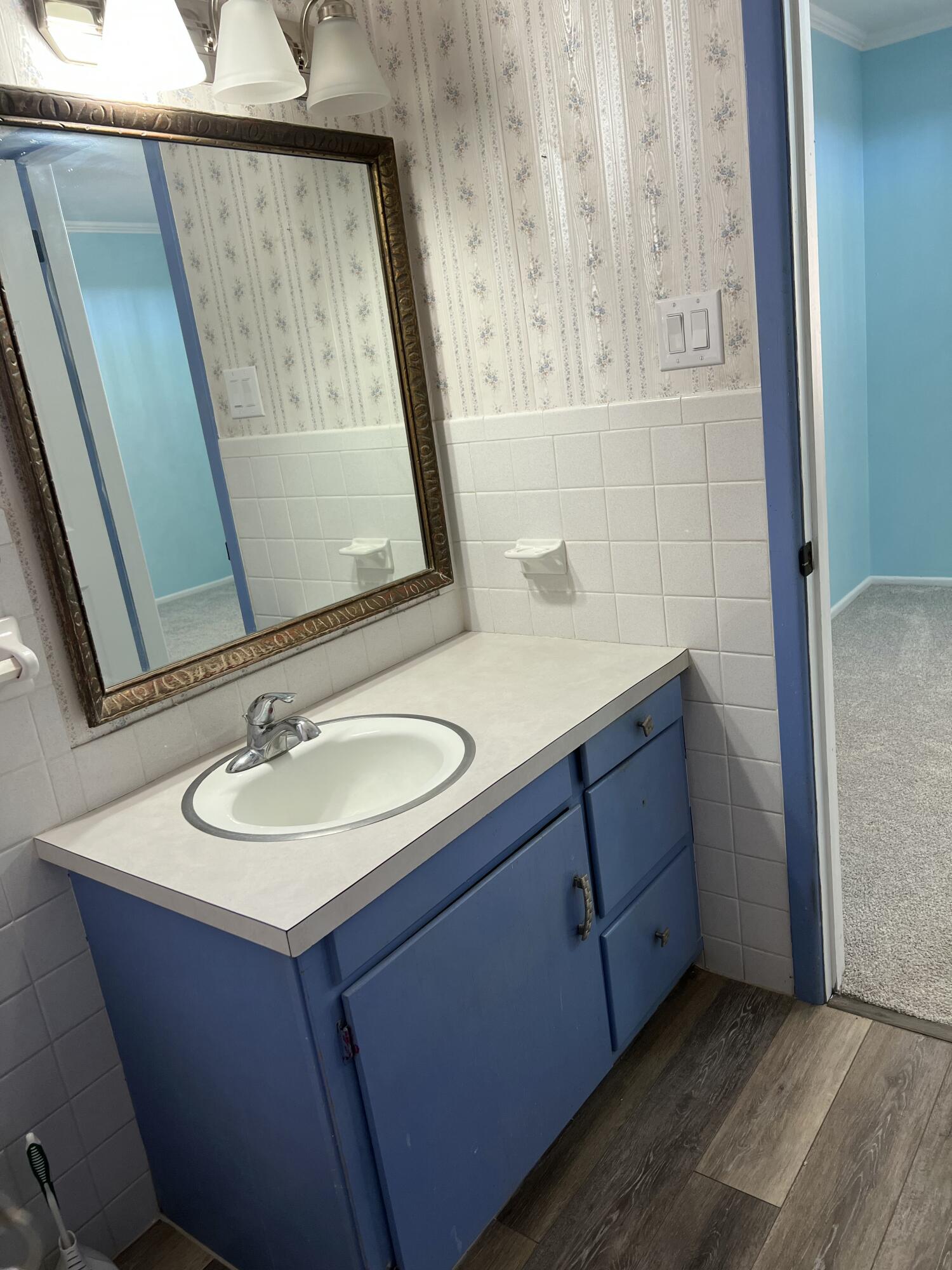 5520 36th Street Lubbock, TX 79407 - Photo 14 of 27 a bathroom with a sink and a mirror
