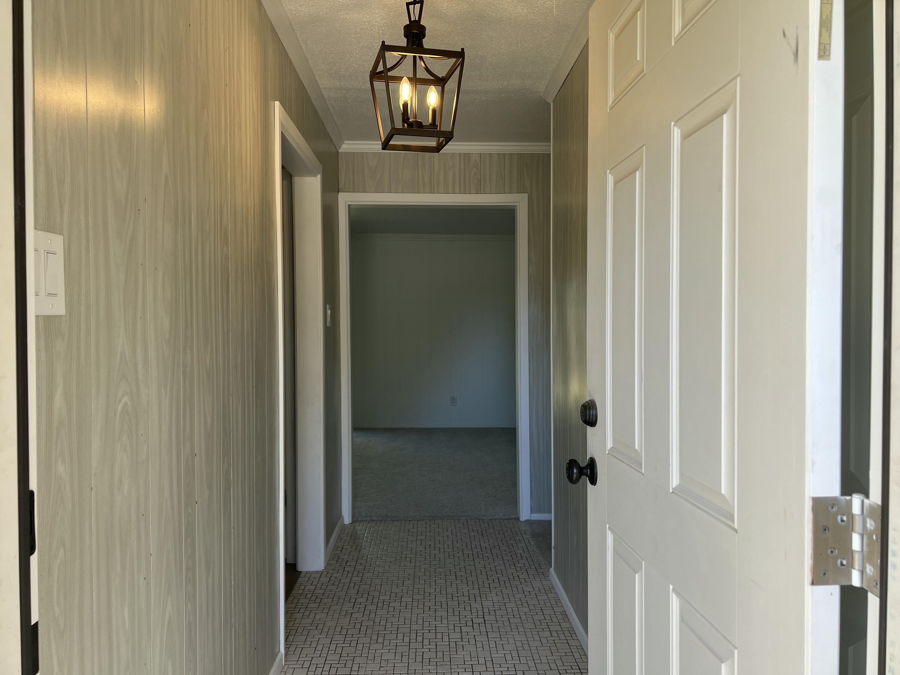 5520 36th Street Lubbock, TX 79407 - Photo 5 of 27 a view of a hallway to front door with wooden floor