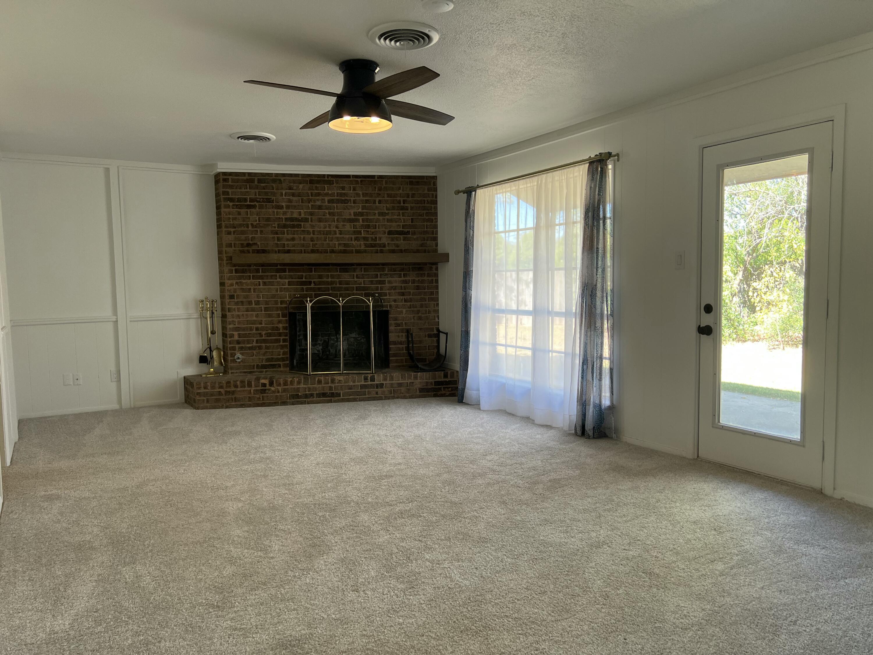 5520 36th Street Lubbock, TX 79407 - Photo 6 of 27 an empty room with windows and fireplace