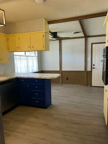 a kitchen with stainless steel appliances granite countertop a refrigerator a sink and dishwasher