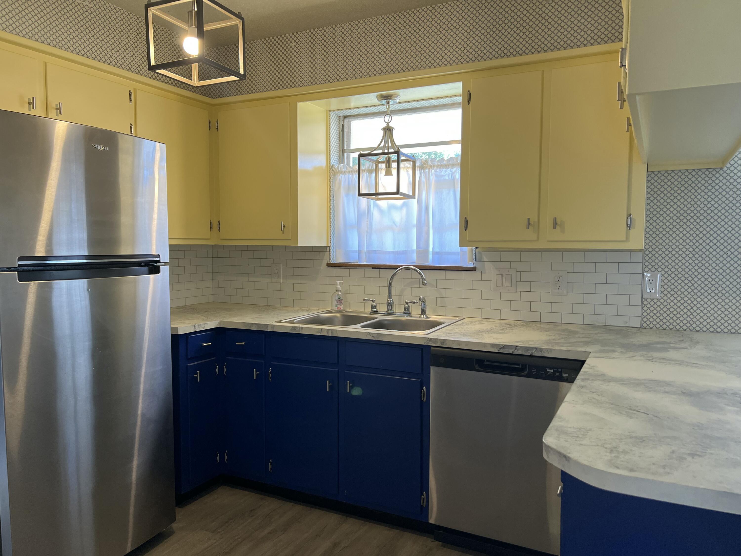 5520 36th Street Lubbock, TX 79407 - Photo 10 of 27 a kitchen with stainless steel appliances granite countertop a refrigerator a sink and dishwasher
