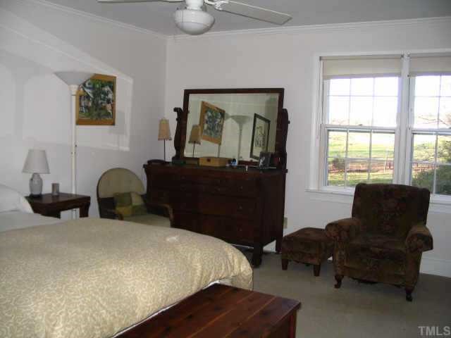 6202 Arrington Road Raleigh, NC 27607 - Photo 9 of 10 a bedroom with a bed and a couch next to a window