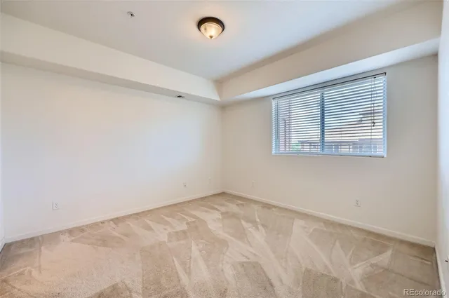 an empty room with a bathroom and a sink