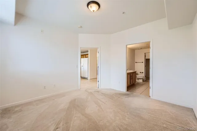 an empty room with closet and a window