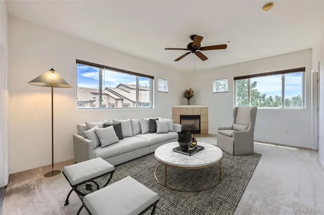 a living room with furniture and a fireplace