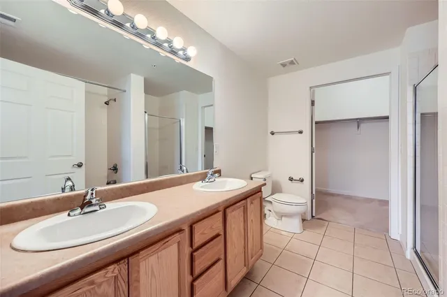 a bathroom with a sink double vanity and a mirror