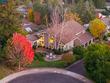 a view of a house with a yard and garden