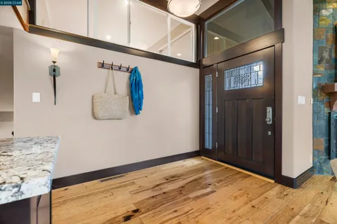 a living room with furniture a dining table and a large window