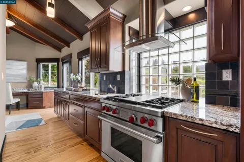 a spacious bedroom with a bed and glass walk in closet