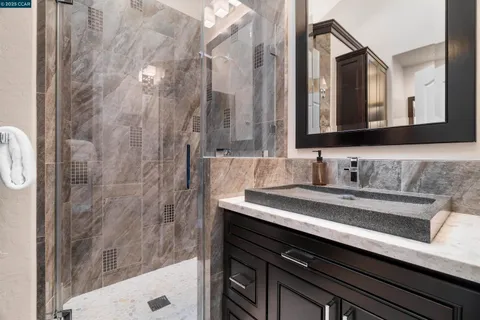 a spacious bathroom with a sink a large mirror and a bathtub