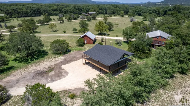 an aerial view of a house with a yard large tree window and a fountain