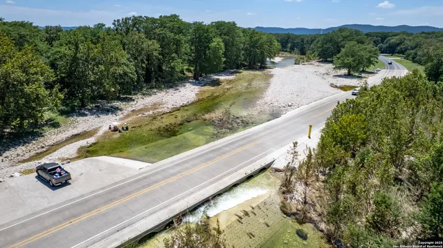 an aerial view of lake and residential houses with outdoor space