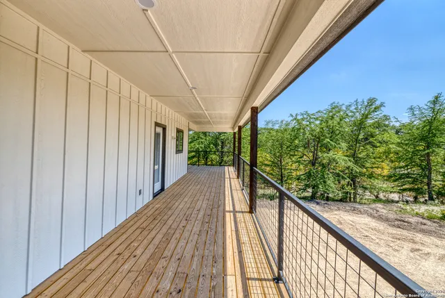 a view of a balcony with wooden floor