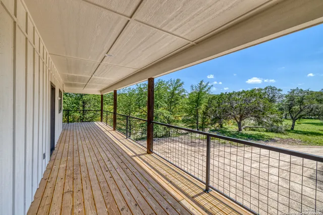 a view of a balcony with wooden floor