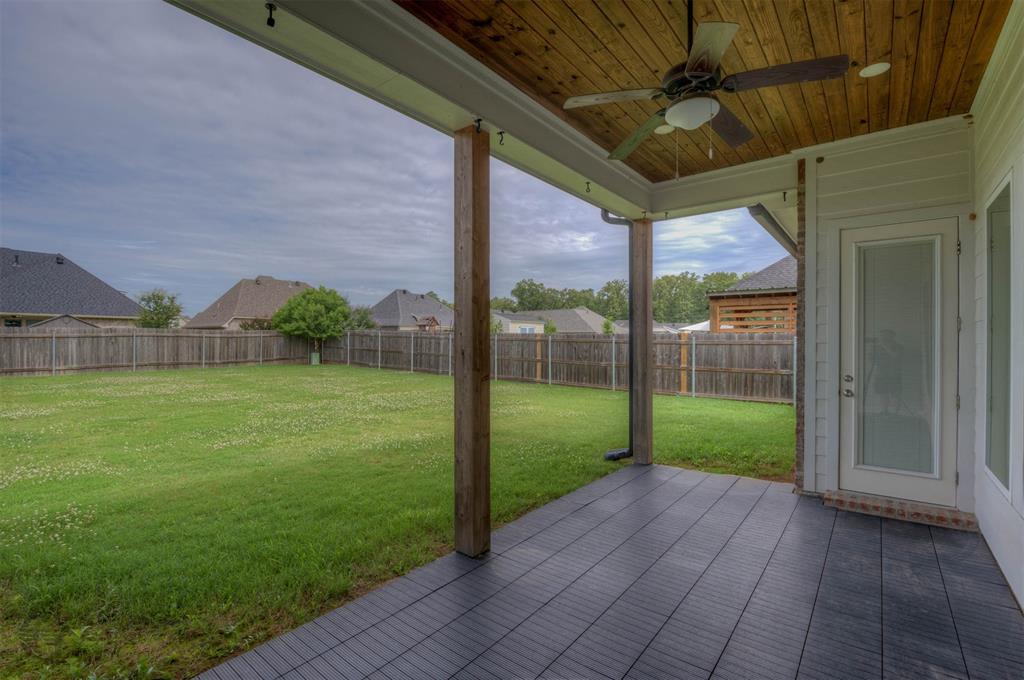 605 Meridian Way Benton, LA 71006 - Photo 26 of 29 Covered patio featuring wood-paneled ceiling, ceiling fan, and dark tile flooring