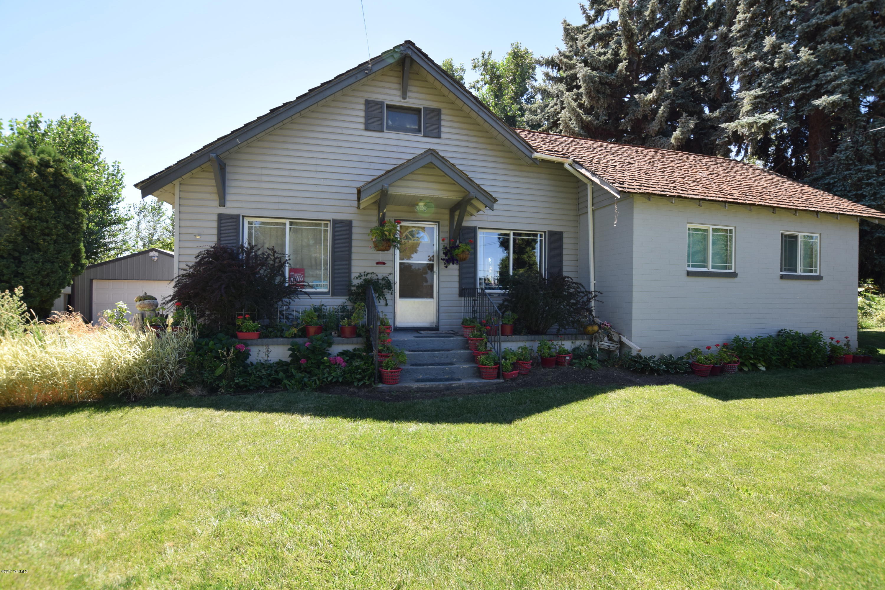 a front view of house with yard and green space
